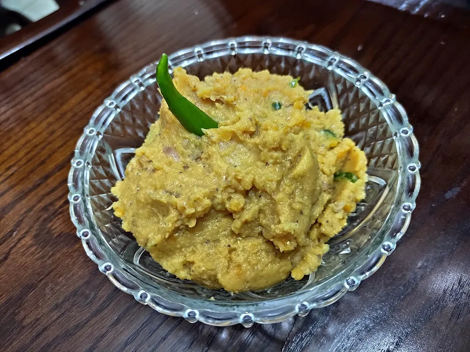 Dal vorta — mashed red lentils with green chili in a glass bowl